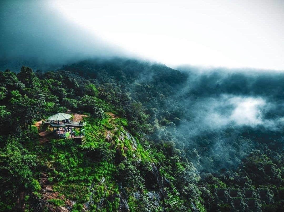 Panoramic view of lush green valleys and misty mountains at Bisle Ghat in Western Ghats"